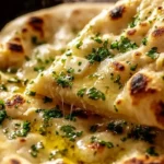 Freshly baked artisan garlic naan with herbs and spices