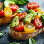 Avocado, tomato, and basil bruschetta served on toasted bread