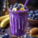 Delicious Banana-Blueberry Smoothie in a glass with fresh fruits