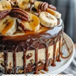 Slice of banana pecan caramel layer cake topped with pecans and caramel drizzle