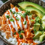 Buffalo Chicken Cottage Cheese Bowl garnished with fresh herbs
