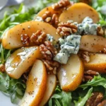 Caramelized pear and blue cheese salad topped with walnuts and greens