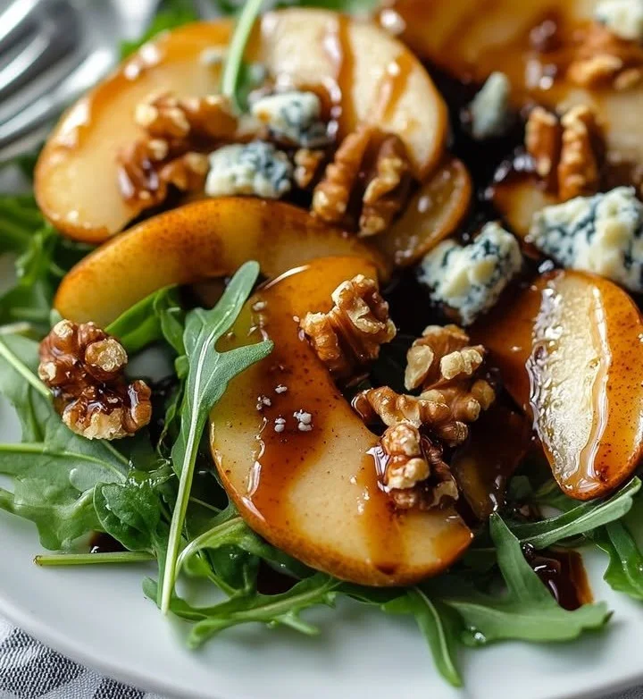 Caramelized pear and blue cheese salad with greens and walnuts