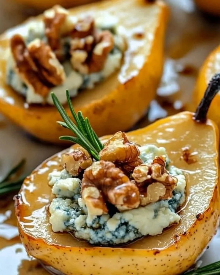 Caramelized pears topped with blue cheese and walnuts on a plate