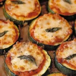 Cheesy Zucchini Pizza Bites topped with fresh ingredients and melted cheese