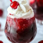 Refreshing Cherry Rum Slushie with cherry garnish and straw