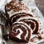 Chocolate Almond Cream Cake Roll sliced to show creamy filling and almond layers