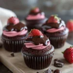 Delicious Chocolate Strawberry Cupcakes topped with fresh strawberries and chocolate frosting.