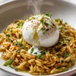 Creamy orzo risotto topped with lemon feta sauce and burrata