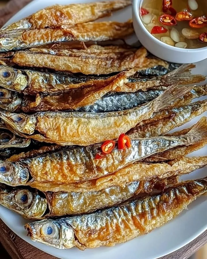 Crispy fried dried fish served on a plate with garnishes