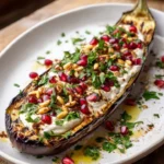 Deconstructed Baba Ghanoush platter with tahini, pomegranate, and pine nuts
