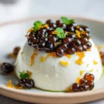 Espresso pearls served on whipped mascarpone with orange zest garnish.