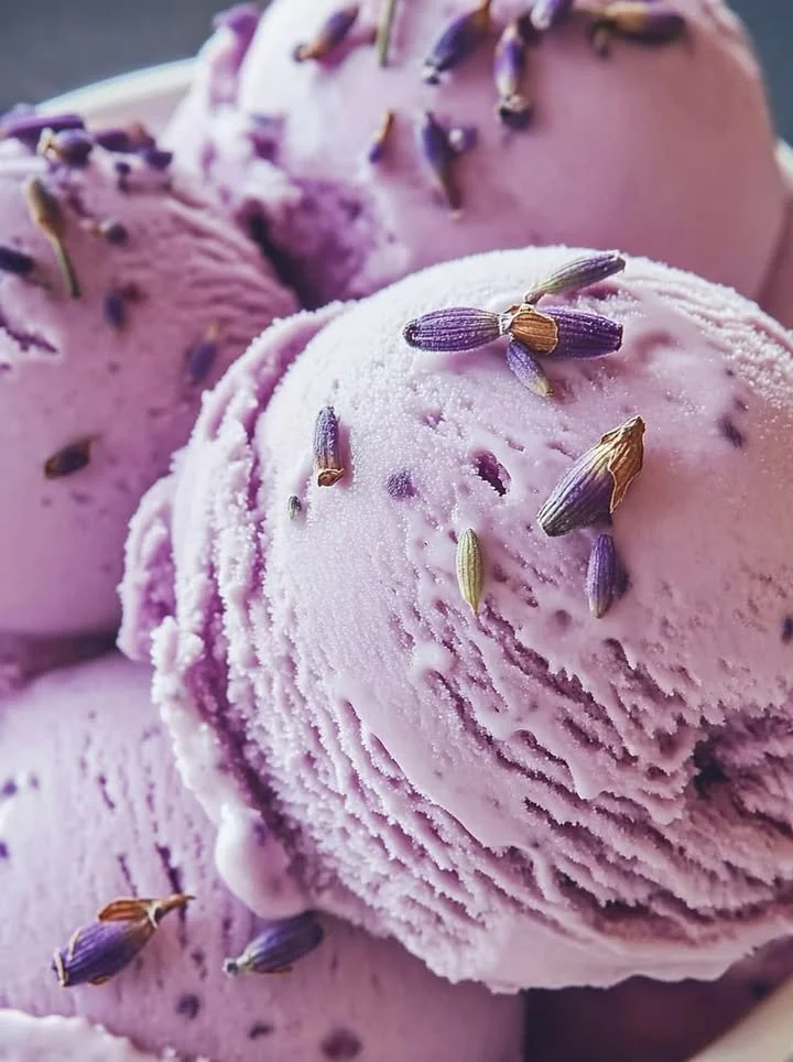 Creamy honey lavender ice cream in a bowl with lavender sprigs