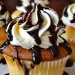 Delicious Boston Cream Pie cupcakes topped with chocolate glaze and cream filling.