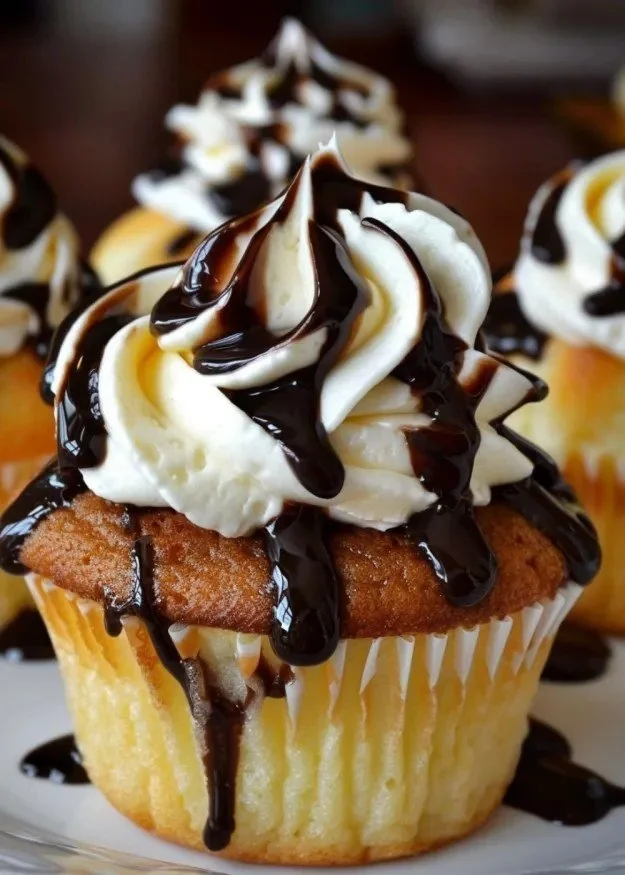 Delicious Boston Cream Pie cupcakes topped with chocolate glaze and cream filling.