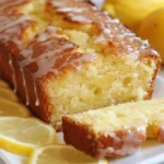 Sliced Lemon Drizzle Cake topped with lemon glaze