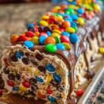 M&M's Chocolate Chip Cookie Dough Ice Cream Cake Roll with colorful toppings