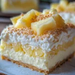 No-bake pineapple cream dessert topped with fresh pineapple slices.