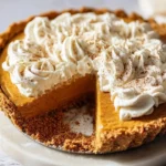 No-bake pumpkin pie topped with whipped cream cloud, a delightful dessert option.