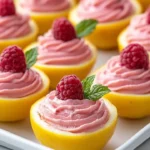 Ricotta raspberry mousse filled in hollowed lemons for a delicious dessert.