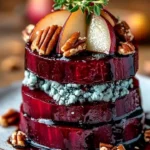 A beautifully plated roasted beet and blue cheese tower appetizer.