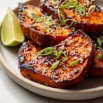 Roasted sweet potato steaks with gochujang-maple glaze on a plate