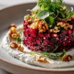 Ruby Beetroot Tartare with whipped goat cheese and walnut-dill crunch served on a plate