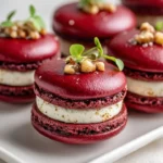 Savory beet macarons with goat cheese filling and walnut crunch topping