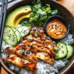 Spicy Honey-Ginger Chicken Bowl with Yum Yum Sauce served in a colorful dish