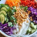 Fresh spring roll salad with spicy ginger dressing served in a bowl.