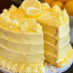 Velvet lemon cream layer cake with fluffy frosting and fresh lemon slices