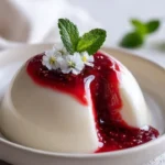 White Burrata Panna Cotta with a liquid raspberry core served in a elegant dish