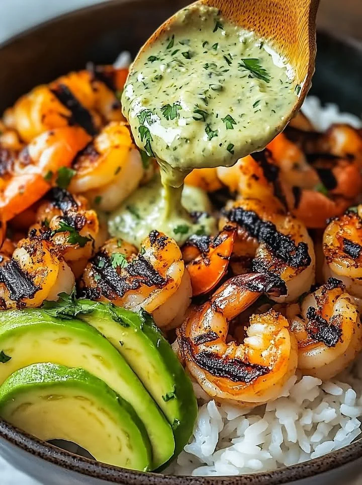 Zesty shrimp avocado rice bowls with cilantro lime sauce served in a bowl